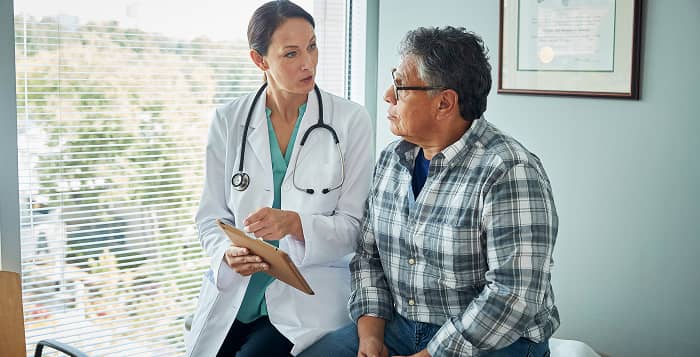 Healthcare provider speaking with a patient about clinical trials offered by Kyntra Bio